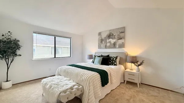 a bedroom with a bed and a window