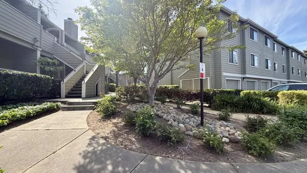 a view of a house with a yard and plants