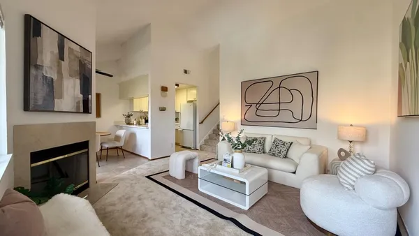 a living room with furniture kitchen view and a fireplace