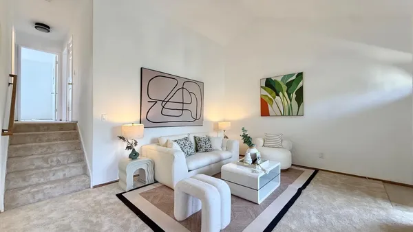 a living room with furniture and a rug