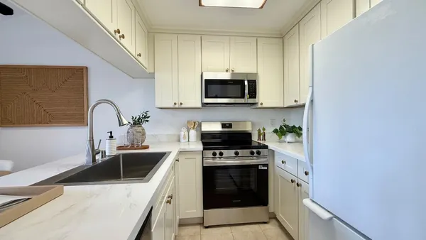a kitchen with granite countertop a sink and steel appliances