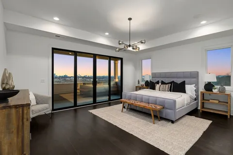 a spacious bedroom with a bed and a lamp