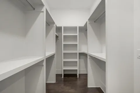 a view of walk in closet with empty racks