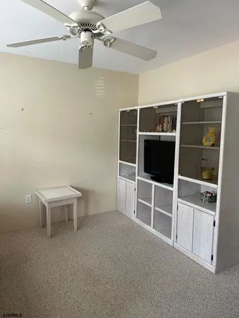 a view of a livingroom with furniture and staircase
