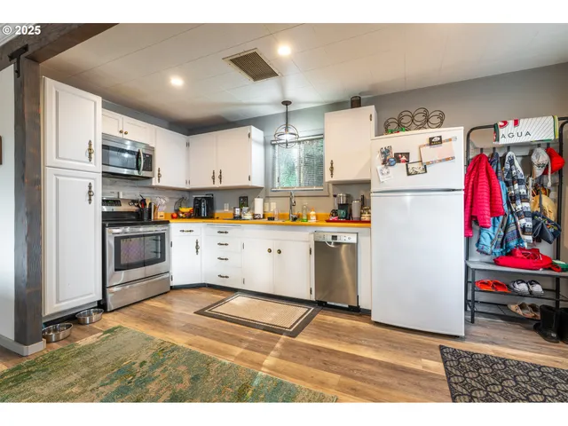a kitchen with stainless steel appliances granite countertop a refrigerator and a stove top oven