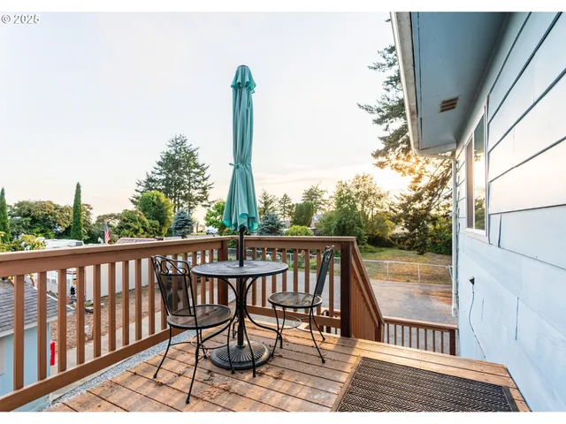 a view of balcony with wooden floor and outdoor seating