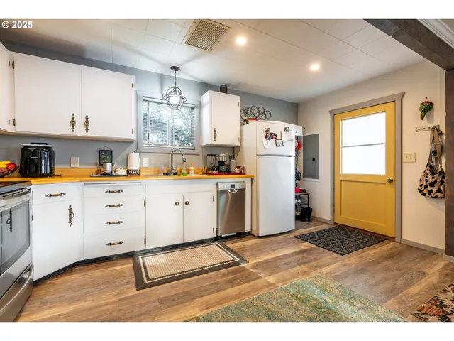 a utility room with cabinets washer and dryer