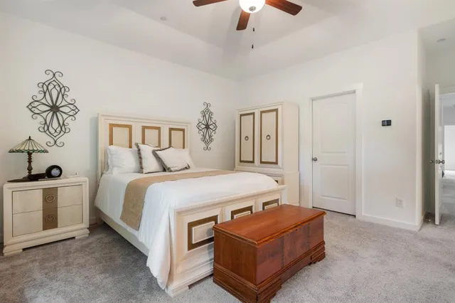 a bed room with a bed and a chandelier