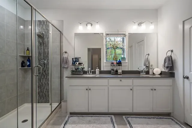 a bathroom with a double vanity sink and a mirror