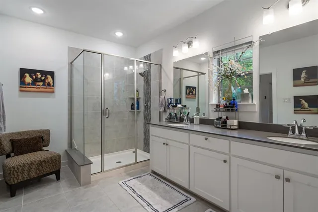 a spacious bathroom with double sink and shower