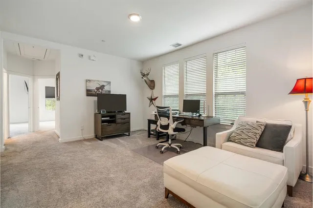 a bedroom with furniture and a flat screen tv