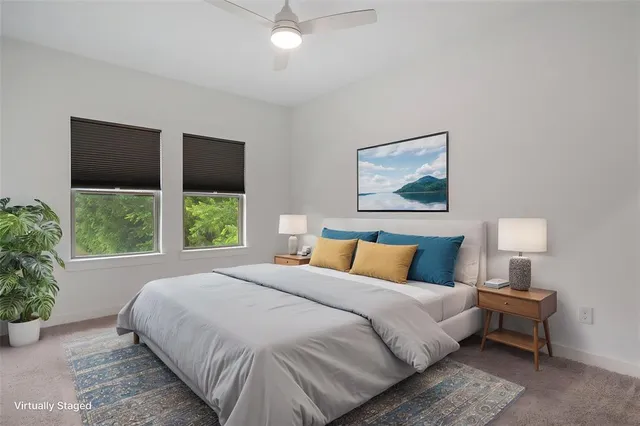 a bedroom with a large bed and a potted plant