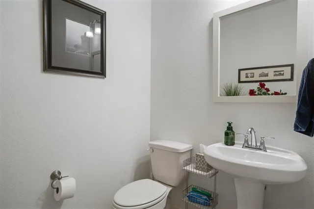 a white toilet sitting next to a bathroom sink