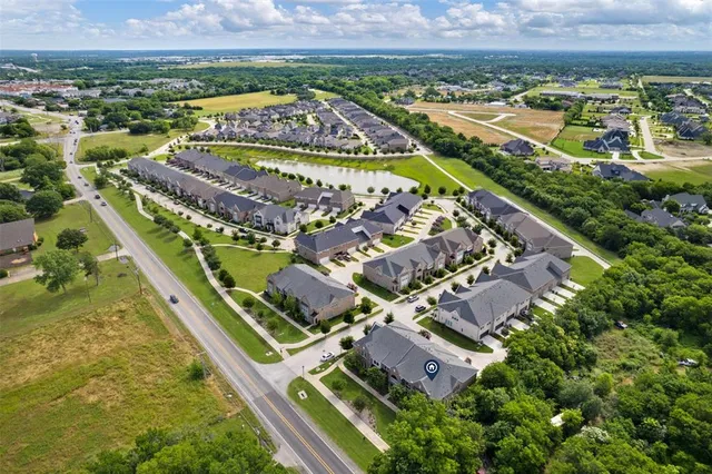 an aerial view of residential houses with outdoor space