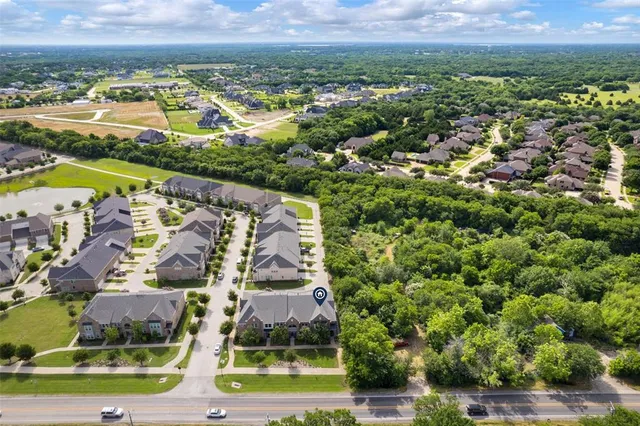 an aerial view of residential building and lake