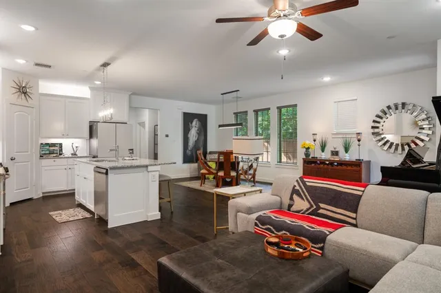 a living room with furniture and kitchen view