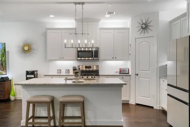 a kitchen with stainless steel appliances a sink stove and refrigerator