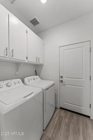 a view of storage and utility room with washer and dryer