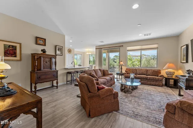 a living room with furniture and a flat screen tv with wooden floor
