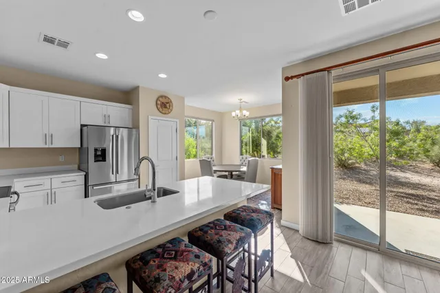 a kitchen with kitchen island a table and chairs in it