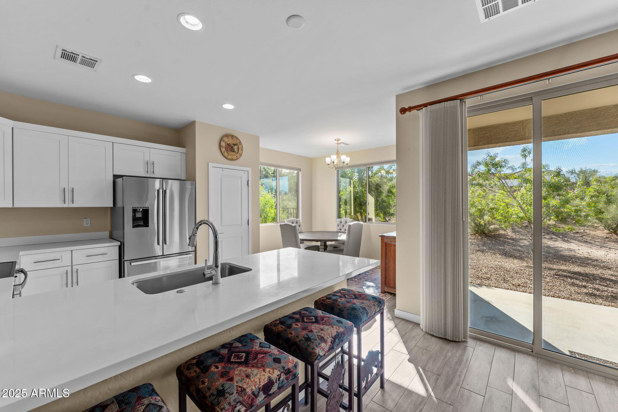 1995 West Ringo Road Wickenburg, AZ 85390 - Photo 9 of 22 a kitchen with kitchen island a table and chairs in it