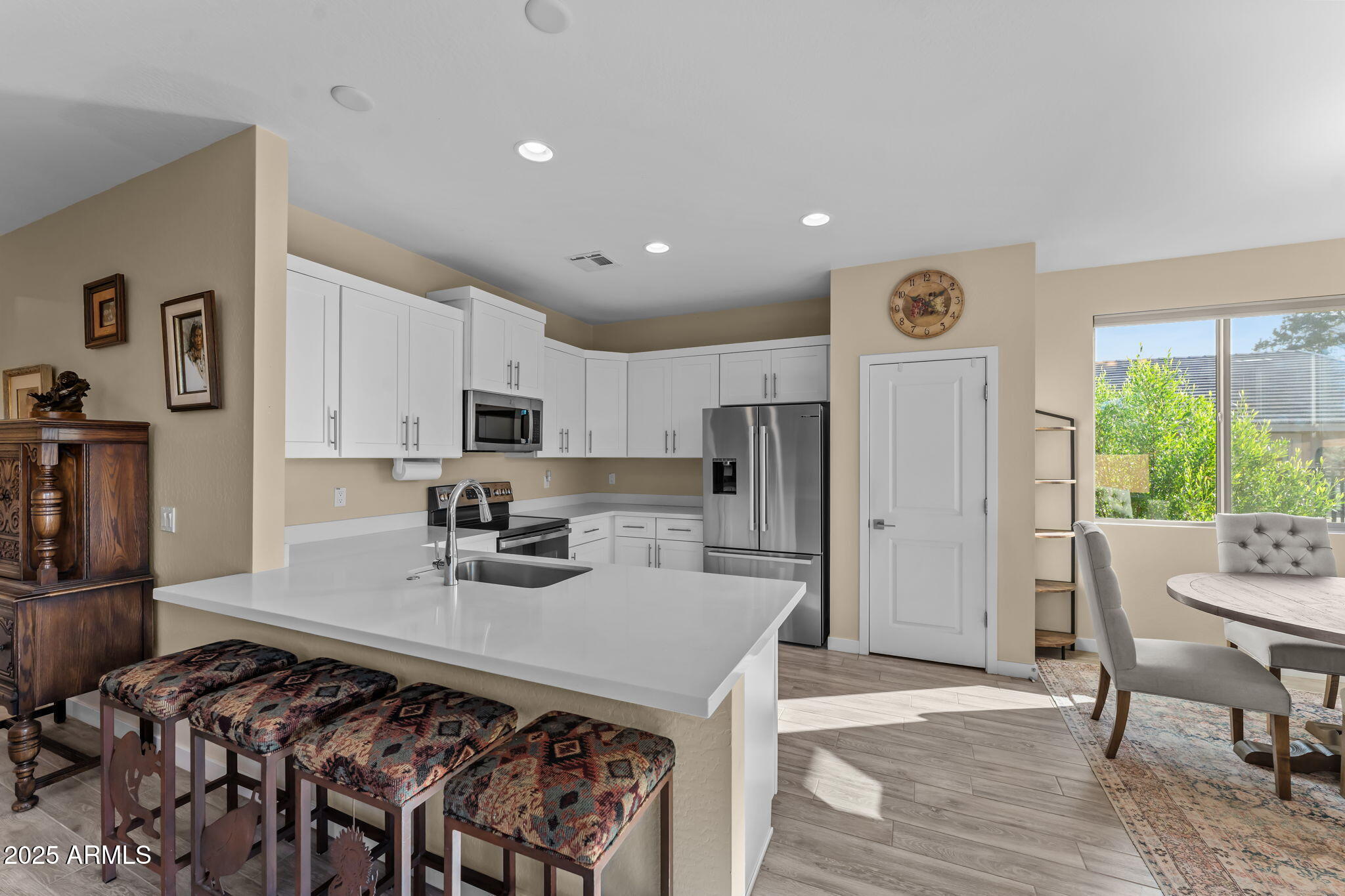 1995 West Ringo Road Wickenburg, AZ 85390 - Photo 10 of 22 a kitchen with stainless steel appliances granite countertop a stove refrigerator sink and cabinets
