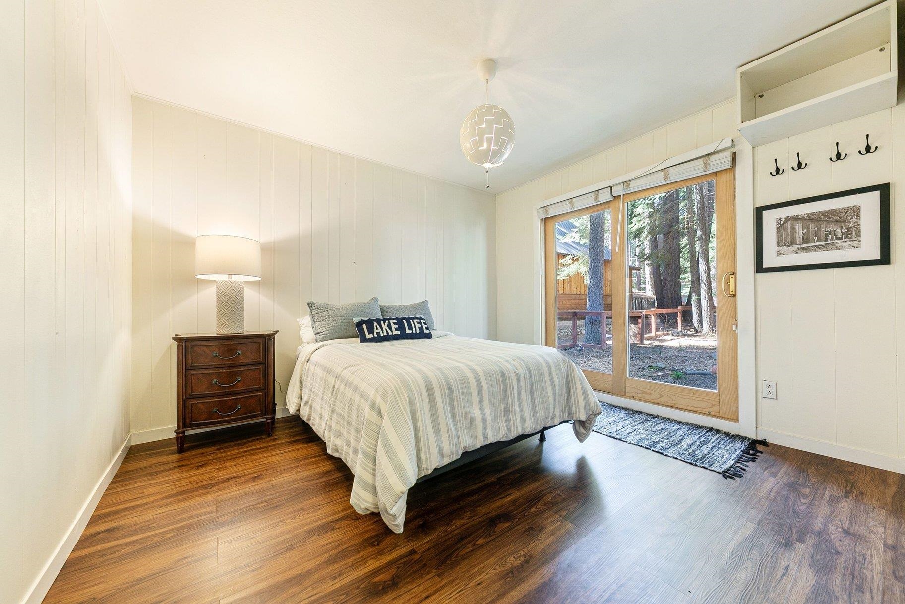 7294 3rd Avenue Tahoma, CA 96142 - Photo 14 of 23 a spacious bedroom with a bed and wooden floor