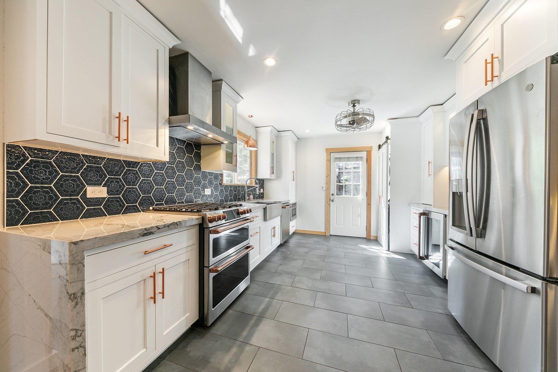 7294 3rd Avenue Tahoma, CA 96142 - Photo 6 of 23 a kitchen with stainless steel appliances granite countertop a stove a refrigerator and a sink