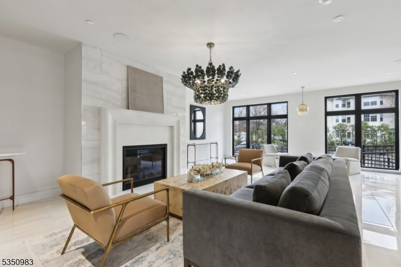 434 Springfield Avenue, Unit 119 Berkeley Heights, NJ 07922 - Photo 15 of 29 a living room with furniture a chandelier and a fireplace