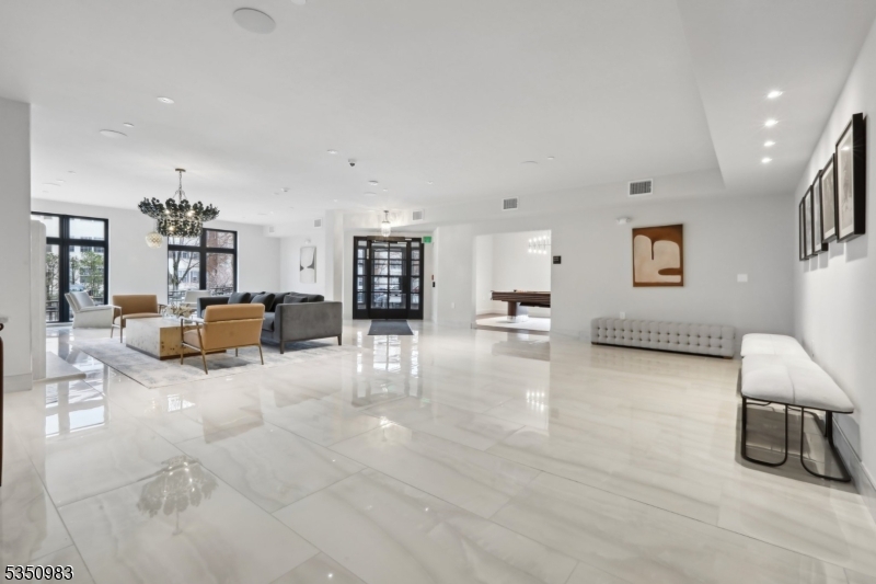 434 Springfield Avenue, Unit 119 Berkeley Heights, NJ 07922 - Photo 16 of 29 a living room with furniture and a flat screen tv