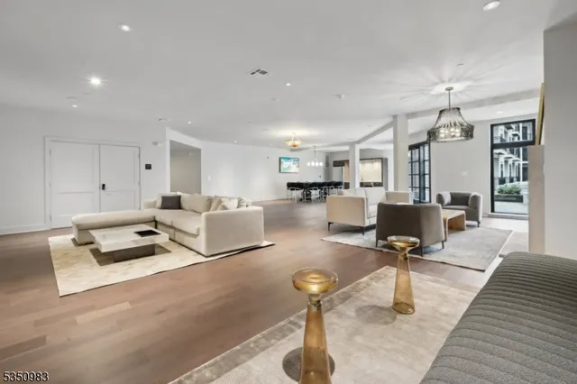 a living room with furniture and a chandelier