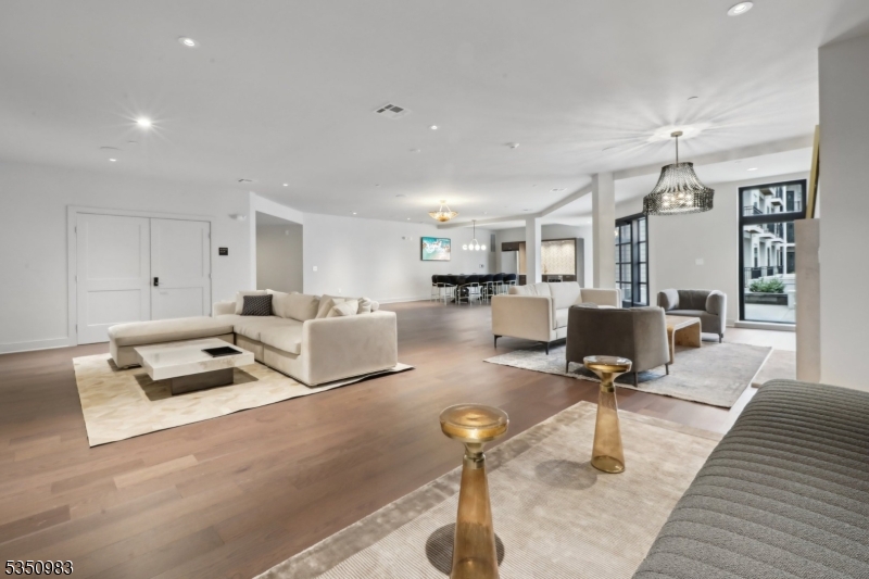 434 Springfield Avenue, Unit 119 Berkeley Heights, NJ 07922 - Photo 17 of 29 a living room with furniture and a chandelier