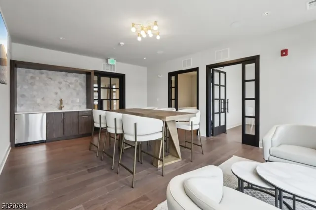 a dining room with furniture a window and wooden floor