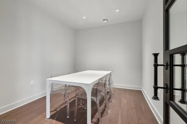 a view of a room with wooden floor