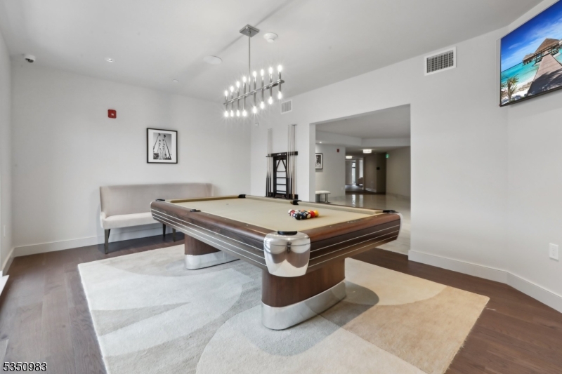 434 Springfield Avenue, Unit 119 Berkeley Heights, NJ 07922 - Photo 22 of 29 a room with pool table and wooden floor