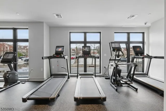 a room with gym equipment and a large window