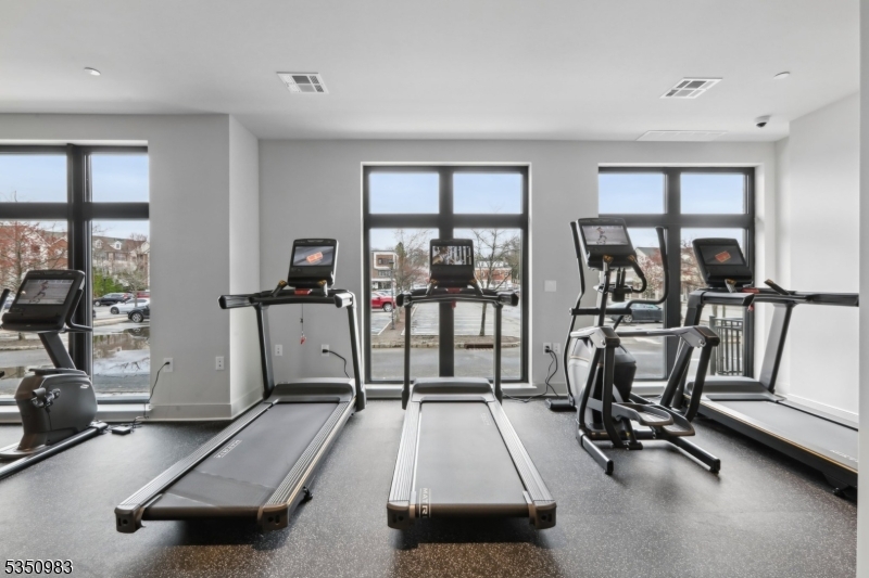 434 Springfield Avenue, Unit 119 Berkeley Heights, NJ 07922 - Photo 27 of 29 a room with gym equipment and a large window