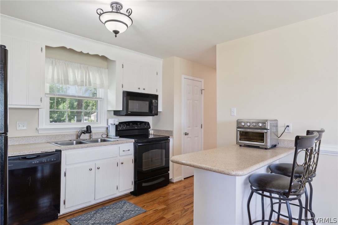 7700 Drexelbrook Road Chesterfield, VA 23832 - Photo 8 of 24 a kitchen with a stove a sink and a microwave