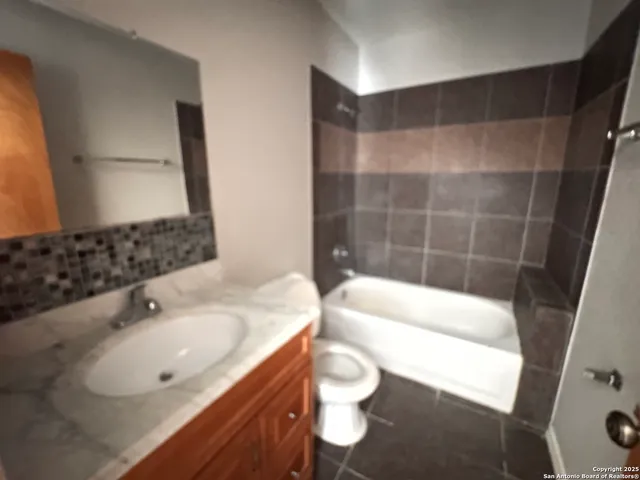 a bathroom with a sink a toilet and bathtub