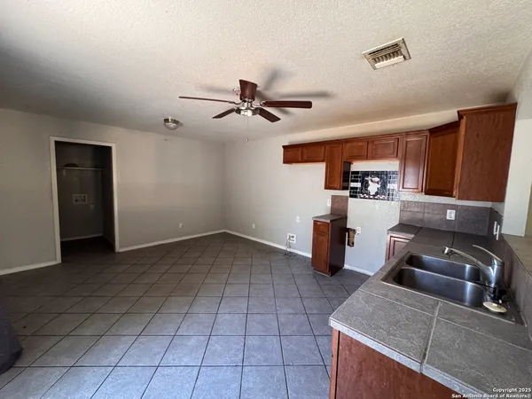 a kitchen with a sink a stove and cabinets