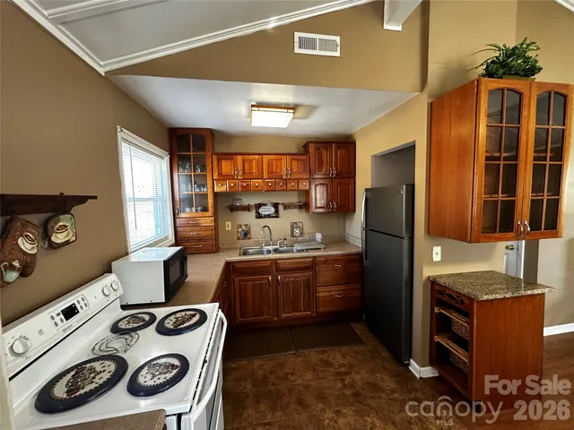 a kitchen with stainless steel appliances granite countertop a stove and a refrigerator