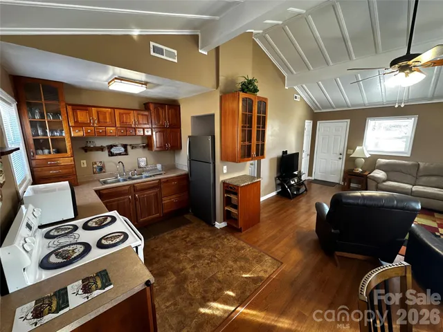 a kitchen with a sink appliances and cabinets