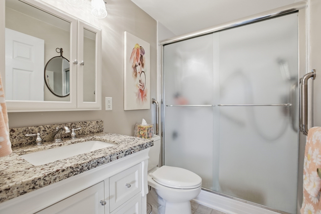 68 Main Street, Unit 36C Stoneham, MA 02180 - Photo 15 of 19 a bathroom with a granite countertop sink toilet and shower