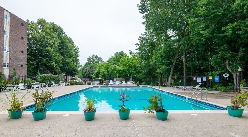 68 Main Street, Unit 36C Stoneham, MA 02180 - Photo 18 of 19 a view of a swimming pool with a patio