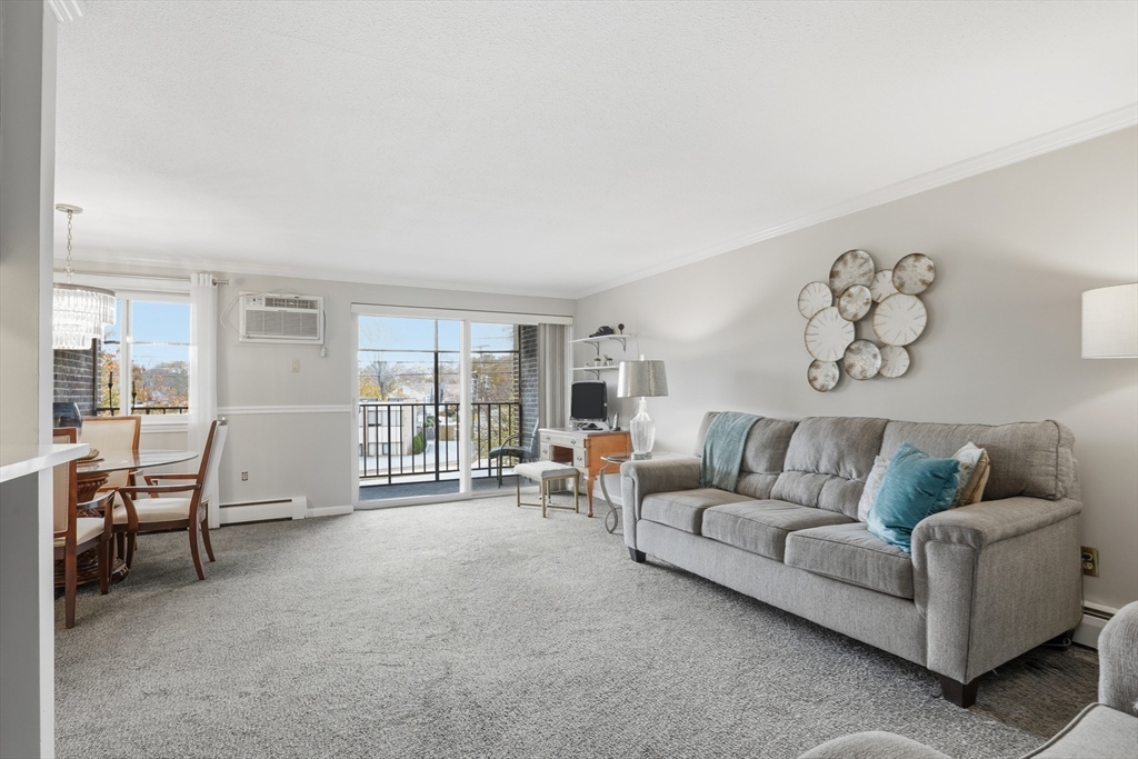 68 Main Street, Unit 36C Stoneham, MA 02180 - Photo 4 of 19 a living room with furniture and a window