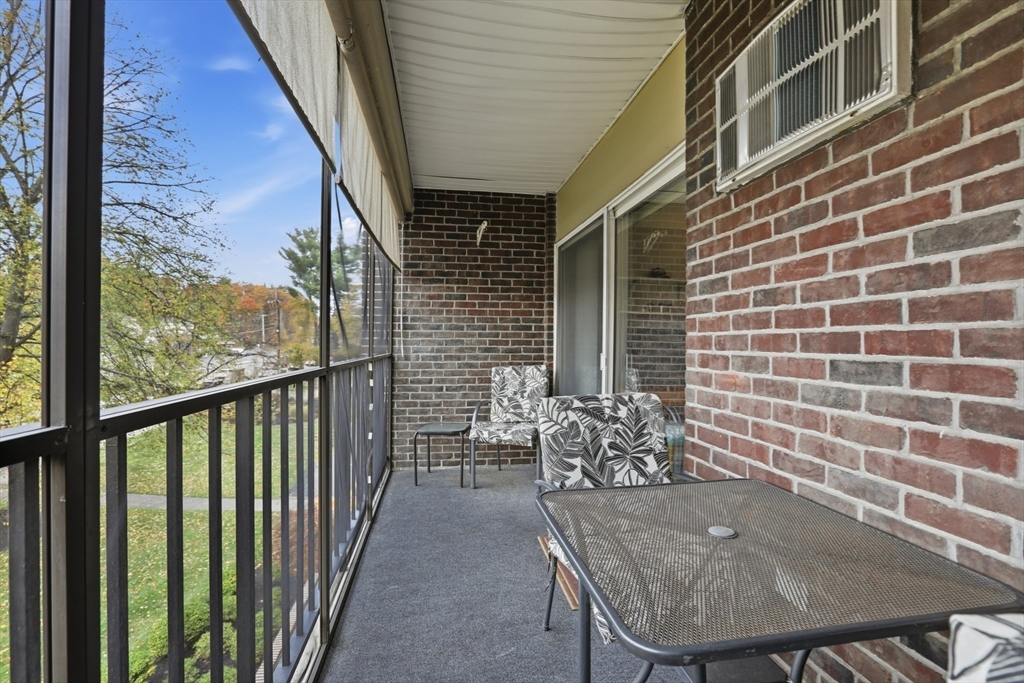 68 Main Street, Unit 36C Stoneham, MA 02180 - Photo 9 of 19 a balcony with table and chairs