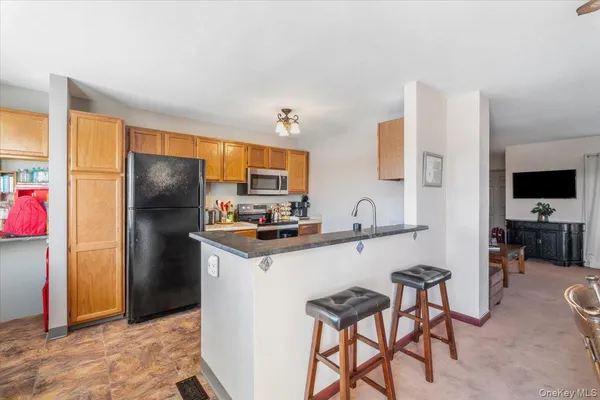 a kitchen with stainless steel appliances a refrigerator and a stove top oven