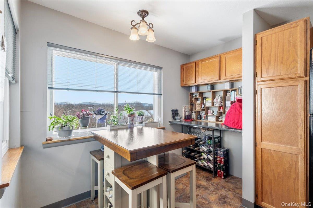 1707 Eagles Ridge Road Brewster, NY 10509 - Photo 16 of 50 a kitchen with a refrigerator and a table