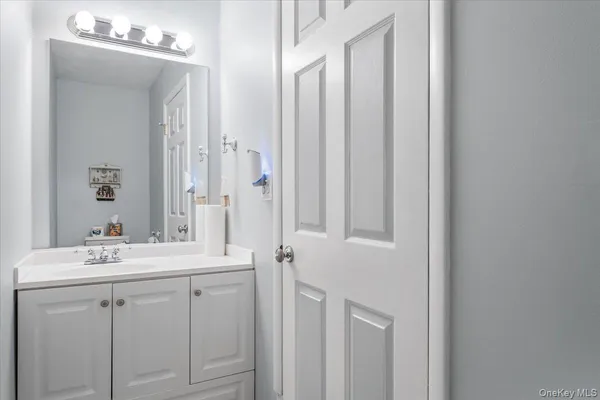 a bathroom with a sink vanity and a mirror