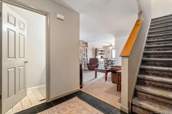 a view of a hallway with wooden floor and stairs